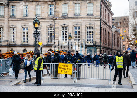 STRASBOURG, FRANCE - DEC 8, 2018: Police surveilling the entrance to Strasbourg Christmas Market near Rohan palace in Strasbourg during winter holiday - city center surveillance Stock Photo