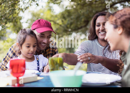 Happy family enjoying lunch at campsite Stock Photo