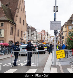 STRASBOURG, FRANCE - DEC 8, 2018: Police surveilling the entrance to Strasbourg Christmas Market in Strasbourg during winter holiday - city center surveillance square image Stock Photo
