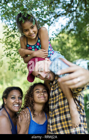 Happy, affectionate family taking selfie with camera phone Stock Photo