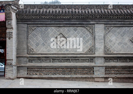 Beautiful Oriental Details On A Traditional Chinese Wall. A Fence Has Made From Grey Tiles. Stock Photo