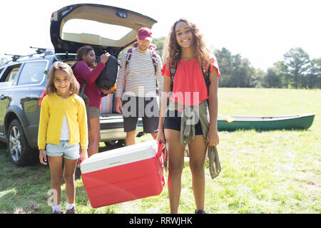 Portrait happy family camping, unloading car Stock Photo