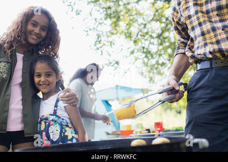 Portrait happy sisters enjoying backyard barbecue Stock Photo