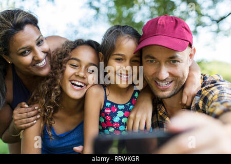 Happy family taking selfie with camera phone Stock Photo