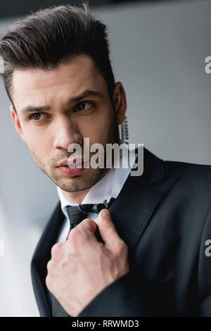 focused bodyguard in suit using microphone Stock Photo