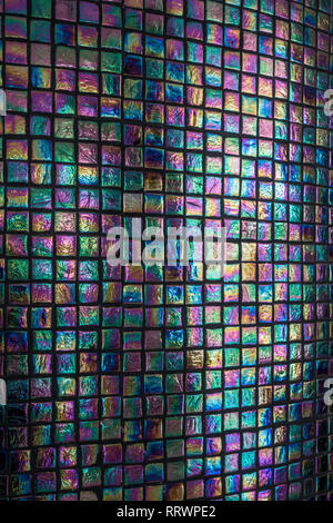 Iridescent tiled column with black grout Stock Photo