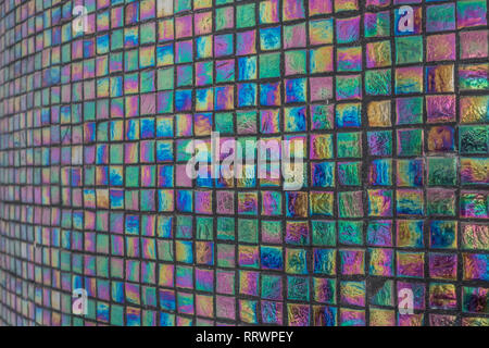 Iridescent tiled column with black grout Stock Photo