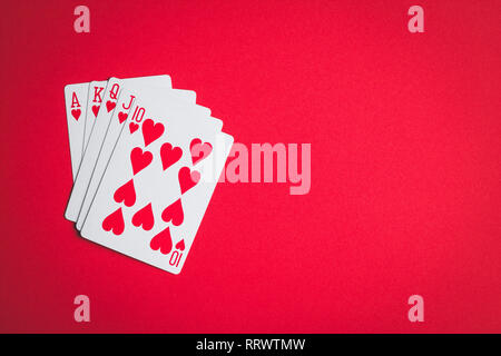 Poker cards. Royal flush on red table. Stock Photo