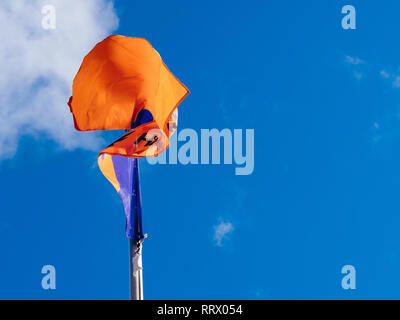 HAMBURG, GERMANY - MAR 20, 2018: Hapag-Lloyd transnational German-based transportation company flag waving against blue sky Stock Photo