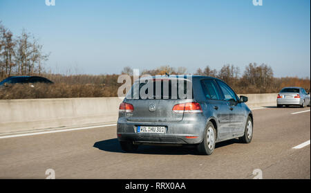 Frankfurt, Germany - Dec 25, 2018: Rear view of blue dirty Volkswagen Golf car driving fast on German autobahn on a winter sunny day Stock Photo