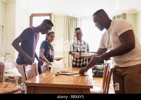 Teenage siblings setting the table Teenage siblings setting the table