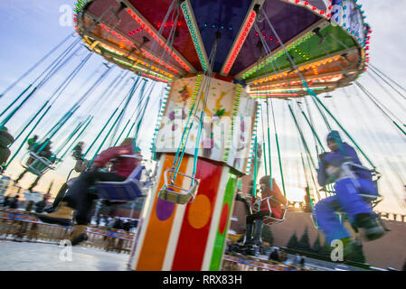 Abstract motion blur carousel spinning with kids, long exposure. Stock Photo