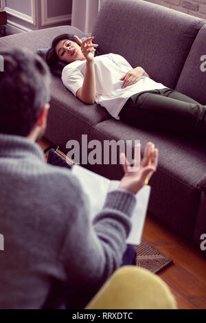 Nice beautiful young woman holding her finger up Stock Photo