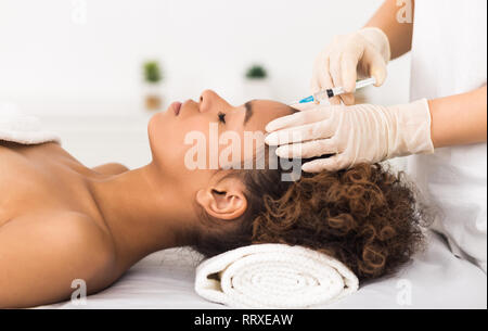 Aesthetic surgery. Woman having injection on forehead Stock Photo