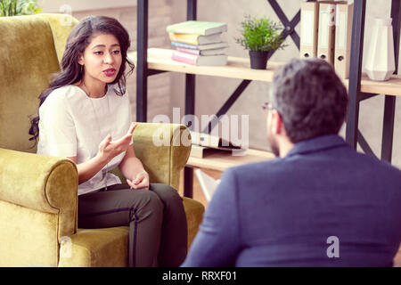 Beautiful nice woman talking to her personal therapist Stock Photo