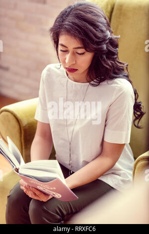 Top view of a serious smart woman reading Stock Photo