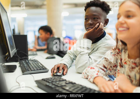 Junior high students using computer in computer lab Stock Photo