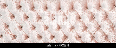 Couch-type velours screed inlaid with rhinestones. Rose chesterfield style quilted upholstery backdrop close up. Capitone pattern texture background Stock Photo