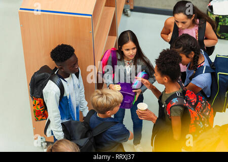 Junior high students talking in library Stock Photo