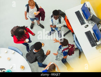 Junior high students talking in library Stock Photo