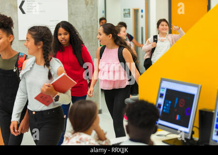 Junior high girl students entering library Stock Photo