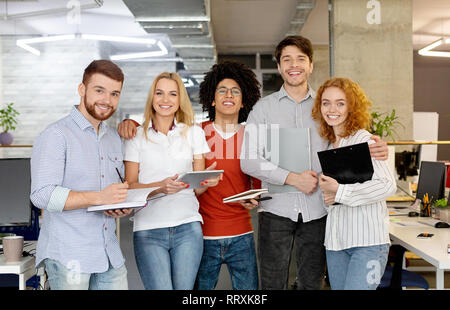 Diverse business people standing together and smiling. Stock Photo
