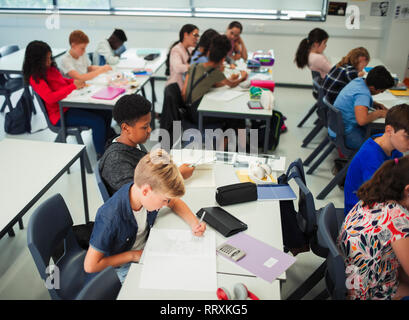 Junior high school students studying in classroom Stock Photo