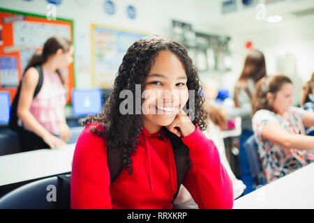 Portrait smiling, confident junior high school girl in classroom Stock Photo