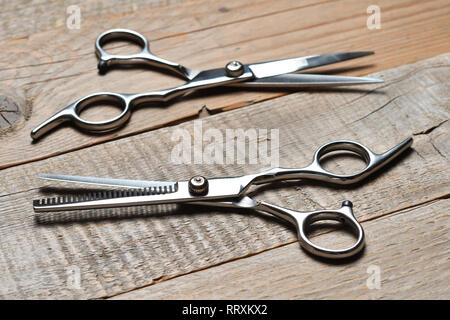 Vintage hairdressing scissors on wooden table Stock Photo