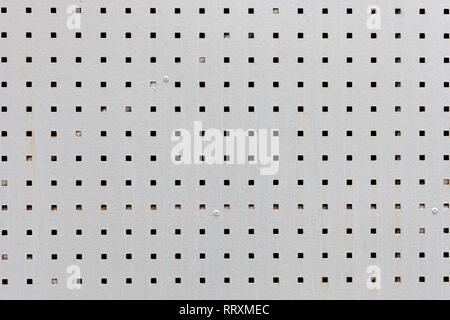 gray metal plate with square black holes. background texture for design Stock Photo