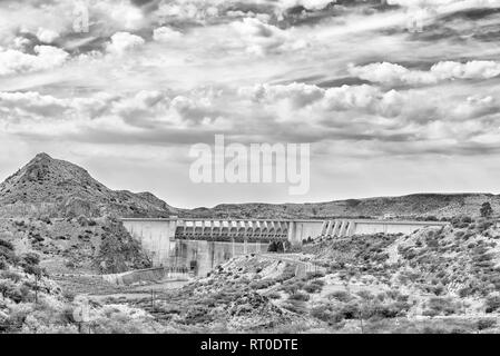 Wall of the Vanderkloof Dam in the Orange River on the border of the Free State and Northern Cape Provinces. Monochrome Stock Photo