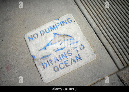 No Dumping, Drains to Ocean sign on sidewalk, Los Angeles, California. Stock Photo