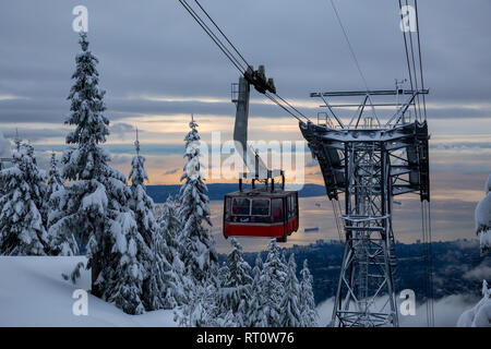 Beautiful view of a Gondola during a vibrant winter sunset. Taken in Grouse Mountain, North Vancouver, BC, Canada. Stock Photo