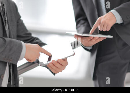close up. two businessmen with tablet computers Stock Photo