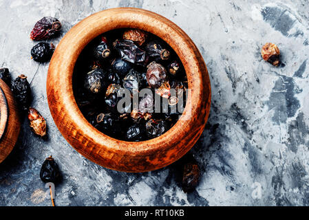 Dried red rose hips in bowl.Dried red fruits of the dog rose Stock Photo