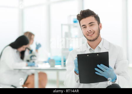 close up. a scientist doing writes the results of an experiment to a laboratory journal Stock Photo