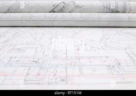 Rolled architectural plans lying on drawing board Stock Photo