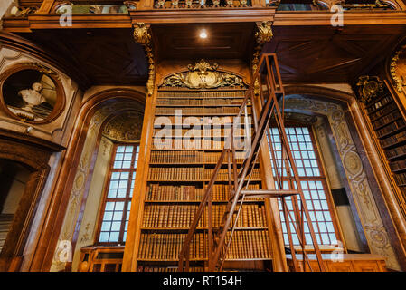 Vienna, Austria - December 24, 2017. Interior of Austrian National Library with wooden ladder and bookshelves. Hapsburg empire's old baroque library h Stock Photo