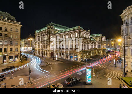 Vienna, Austria - December 30, 2017. Night view of traffic lights and famous landmark - Vienna State Opera building exterior at Ringstrasse boulevard  Stock Photo