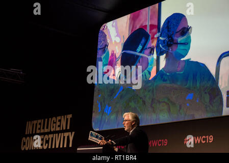Barcelona, Spain. 27th Feb, 2019. Dr Antonio de Lacy speaks as the screen features  a demonstration of the first 5G tele-mentored live surgery in real-time during the  GSMA Mobile World Congress 2019 in Barcelona, the world's most important event on mobile devices communications bringing together the leading companies and the latest developments in the sector. Stock Photo