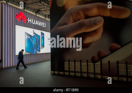 Barcelona, Spain. 27th Feb, 2019. An attendee walks towards Huawei pavilion during the  GSMA Mobile World Congress 2019 in Barcelona, the world's most important event on mobile devices communications bringing together the leading companies and the latest developments in the sector. Stock Photo
