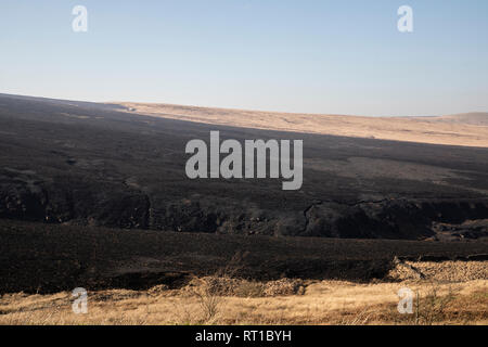 Marsden, UK. 27th Feb, 2019. Scorched moorland was still smouldering this afternoon following the dramatic fire overnight at Marsden Moor, near Saddleworth Moor. Credit: James Copeland/Alamy Live News Stock Photo