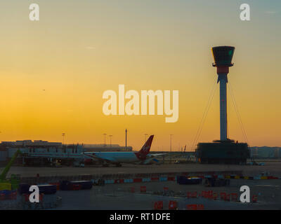 Heathrow Airport. London, UK 27 Feb 2019 - A view of  Virgin Atlantic on tarmac and the control tower during a golden sunset at Heathrow Airport.   Credit: Dinendra Haria/Alamy Live News Stock Photo