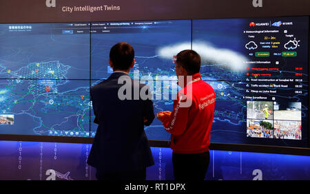 Barcelona, Spain. 27th Feb, 2019. Visitors to the Mobile World Congress look at multiple screens from Huawei. The Mobile World Congress runs from 25 to 28 February. Credit: Clara Margais/dpa/Alamy Live News Stock Photo