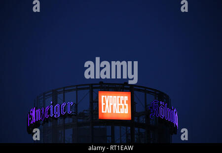 27 February 2019, North Rhine-Westphalia, Köln: The lettering of the newspaper titles 'Kölner Stadt-Anzeiger' and 'Express' light up on the roof of the Neven DuMont House in the evening. The DuMont Media Group is considering a reorientation of its activities and does not exclude the sale of parts of companies. The DuMont-Group includes the 'Kölner Stadt-Anzeiger', 'Express', 'Berliner Zeitung', 'Berliner Kurier', 'Mitteldeutsche Zeitung' and 'Hamburger Morgenpost'. Photo: Oliver Berg/dpa Stock Photo