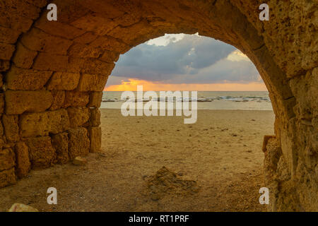 Sunset view of and arch of the Roman Aqueduct in Caesarea, Northern Israel Stock Photo