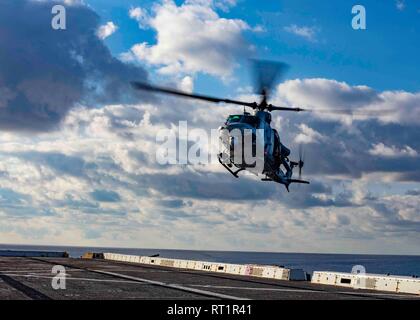 190221-N-HG389-0042 MEDITERRANEAN SEA (Feb. 21, 2019) A UH-1Y Huey helicopter assigned to the “Black Knights” of Marine Medium Tiltrotor Squadron (VMM) 264 (Reinforced) prepares to land on the flight deck of the San Antonio-class amphibious transport dock ship USS Arlington (LPD 24), Feb. 21, 2019. Arlington is on a scheduled deployment as part of the Kearsarge Amphibious Ready Group in support of maritime security operations, crisis response and theater security cooperation, while also providing a forward naval presence. (U.S. Navy photo by Mass Communication Specialist 2nd Class Brandon Park Stock Photo