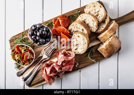 Italian antipasti with mediterranean olives, parma ham, salami and ciabatta bread Stock Photo