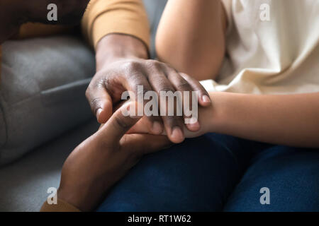 African father holding hands of child as charity support concept Stock Photo