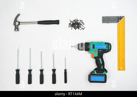 Collection of instruments and nails on white backdrop Stock Photo